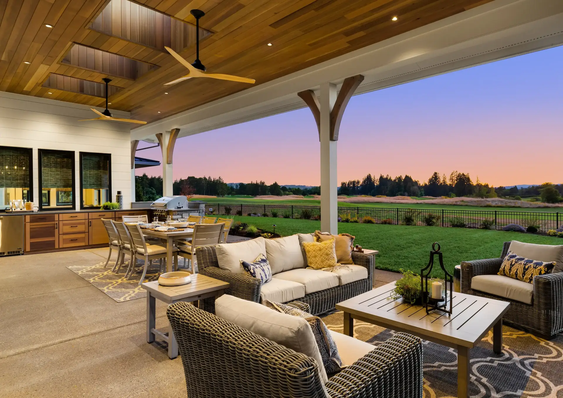 Outdoor patio with furniture at sunset.